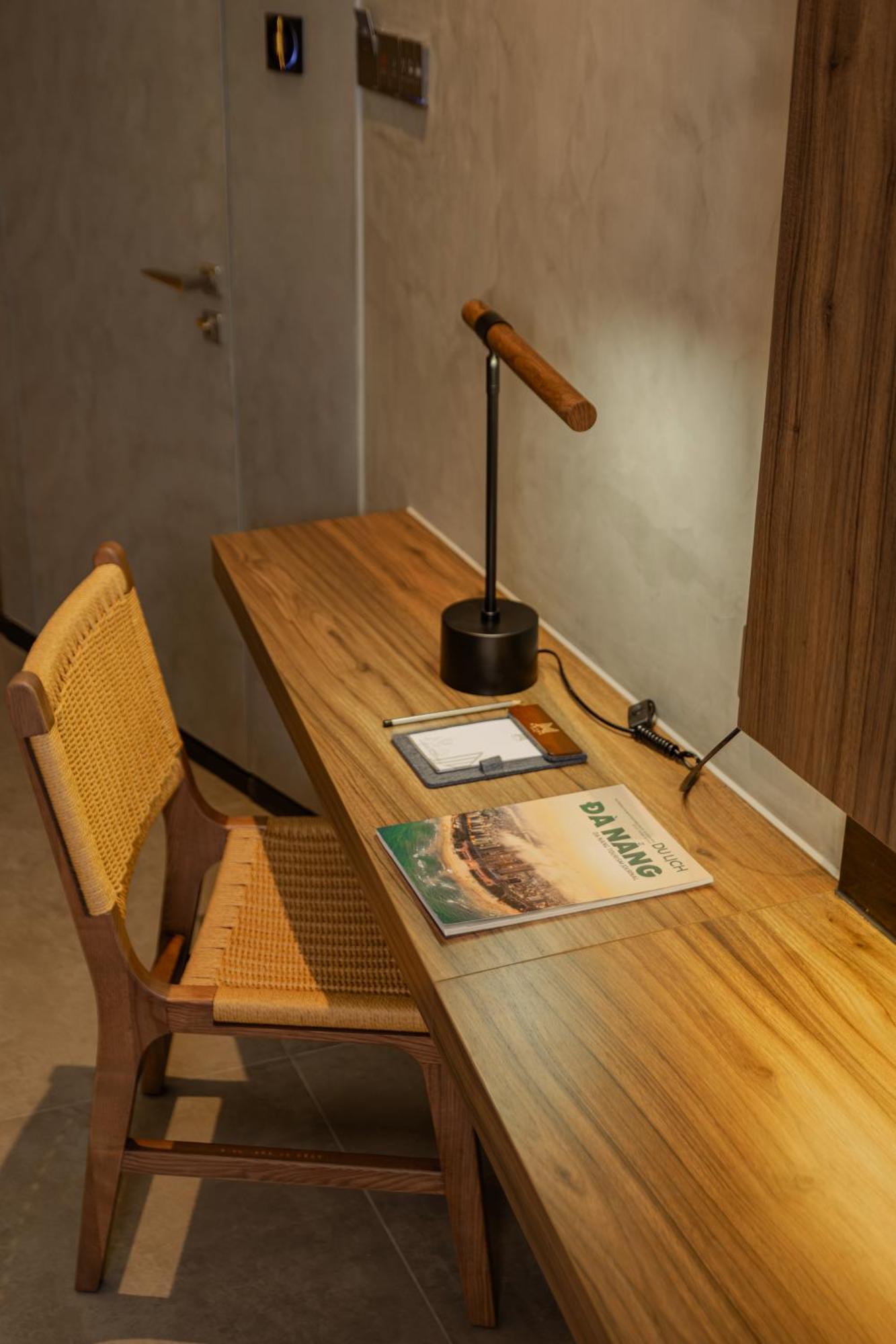 M Hotel Danang Kültér fotó A desk with a magazine on it
